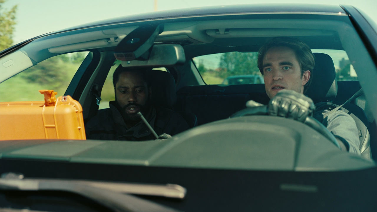 John David Washington as the Protagonist and Robert Pattinson as Neil inside a car in Tenet