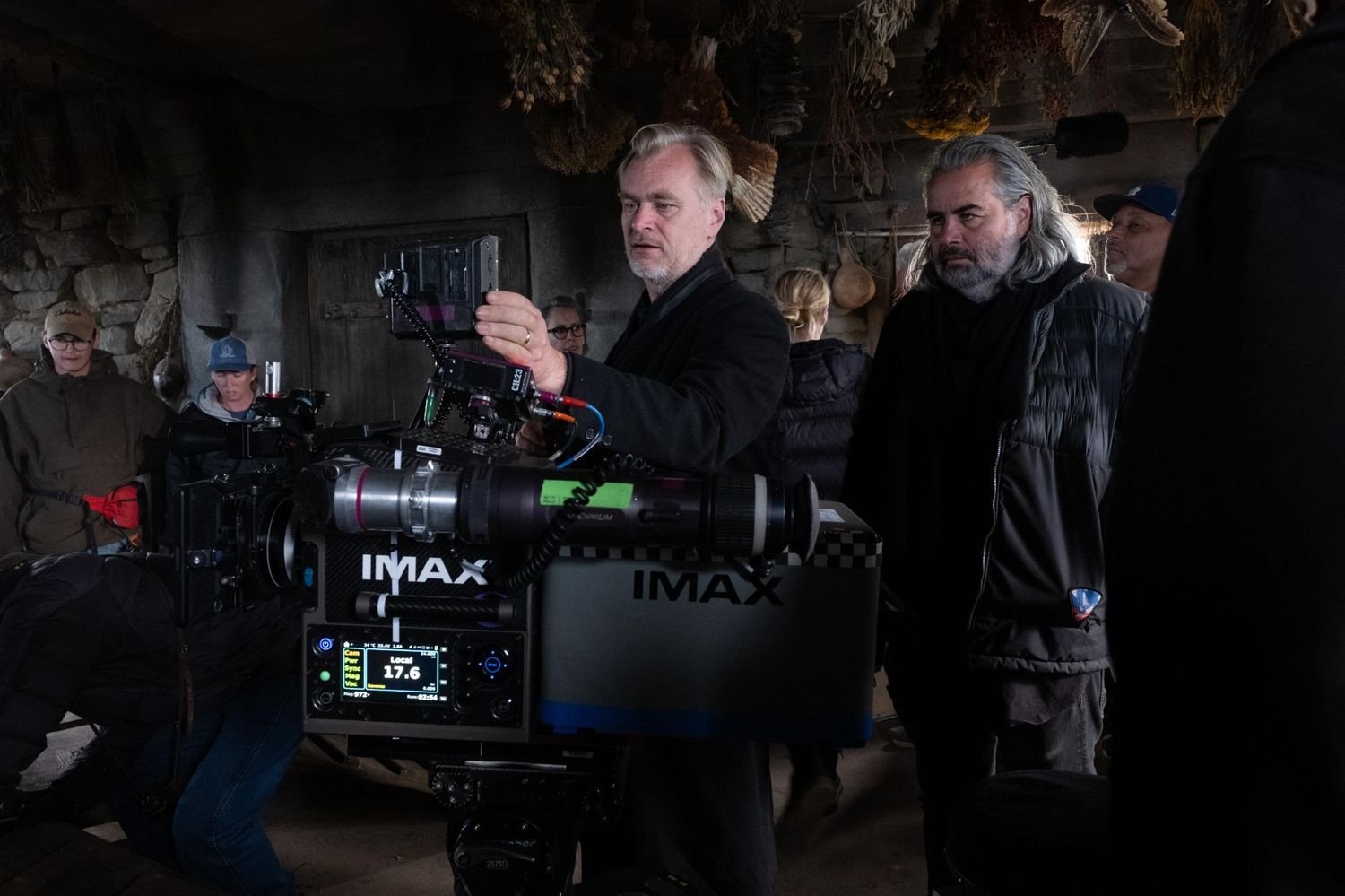 Christopher Nolan and cinematographer Hoyte van Hoytema working with an IMAX film camera behind the scenes of The Odyssey (2026)