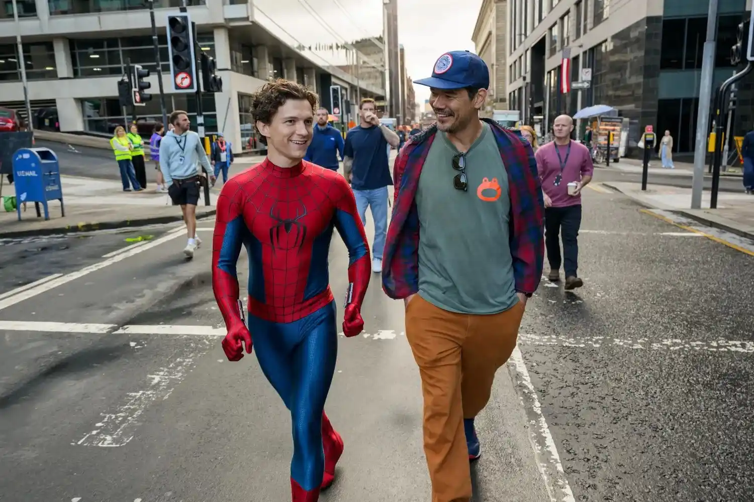 Tom Holland as Spider-Man walking with director Destin Daniel Cretton on the set of Brand New Day