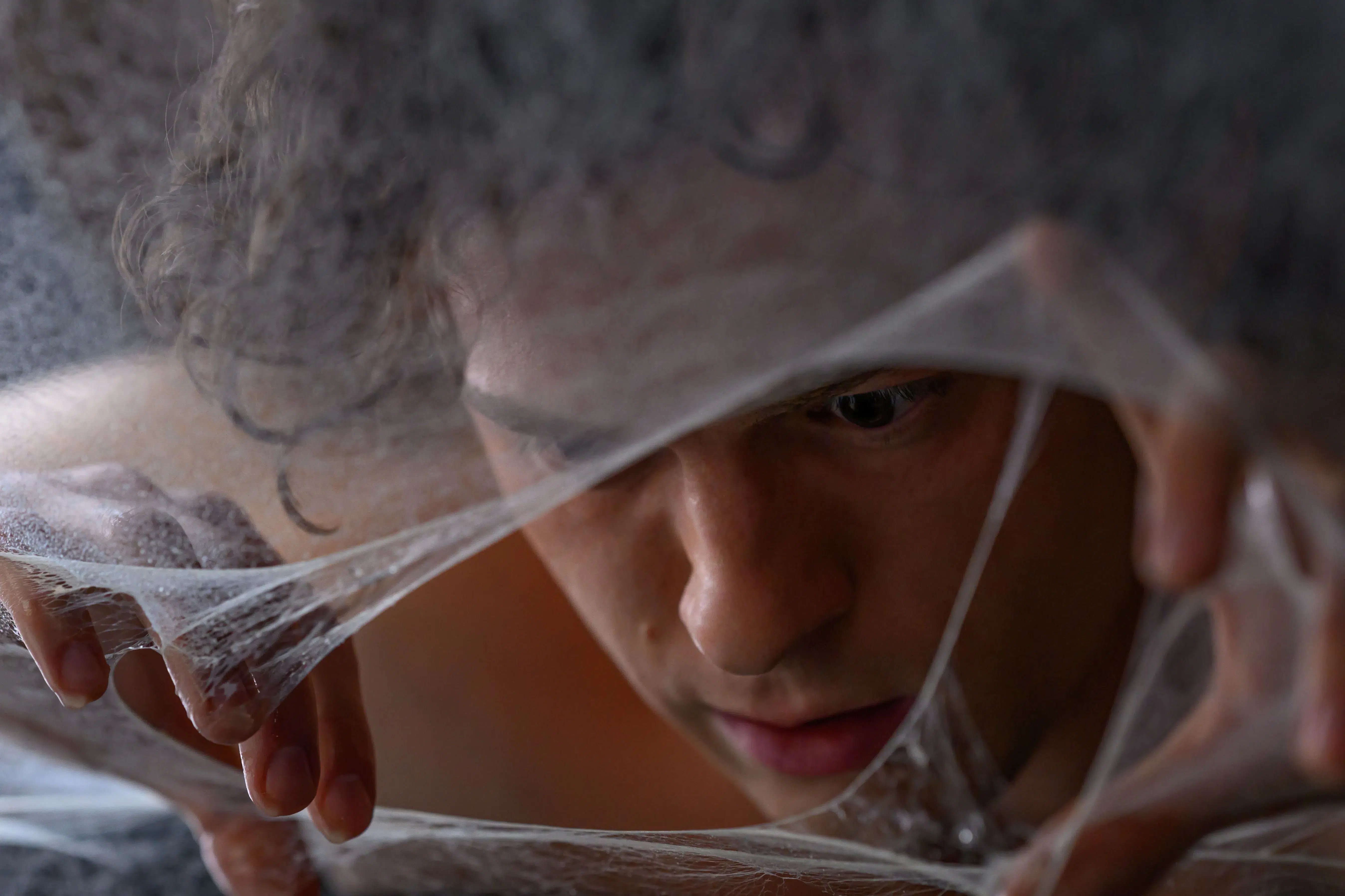 Tom Holland as Peter Parker surrounded by organic webbing in Spider-Man: Brand New Day